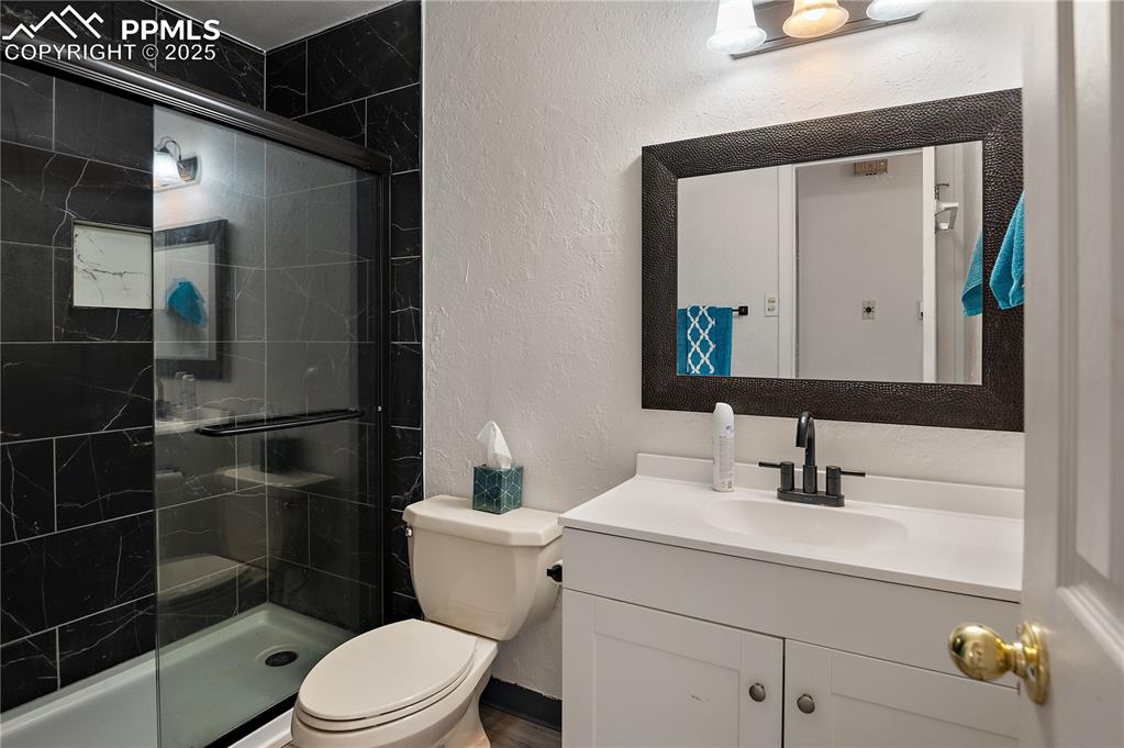 Image 14 of 25: Updated 3/4 Bathroom With Luxury-Vinyl Plank Flooring, Custom Tiles Shower 