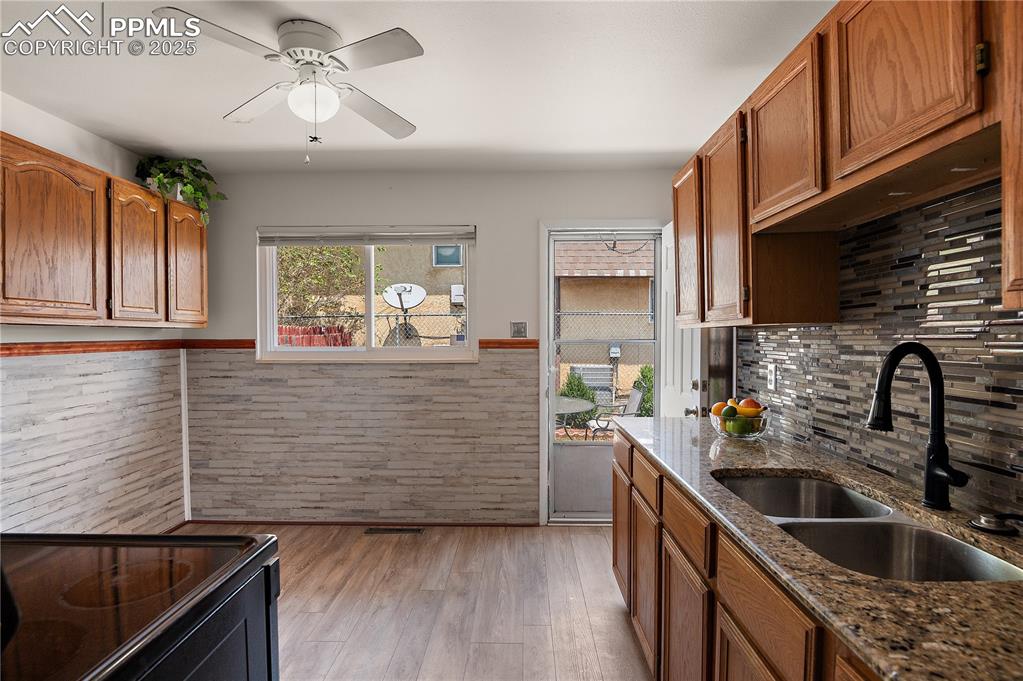 Image 19 of 25: The Updated Kitchen has Luxury Vinyl Plank Flooring and Walks Out to the Pa