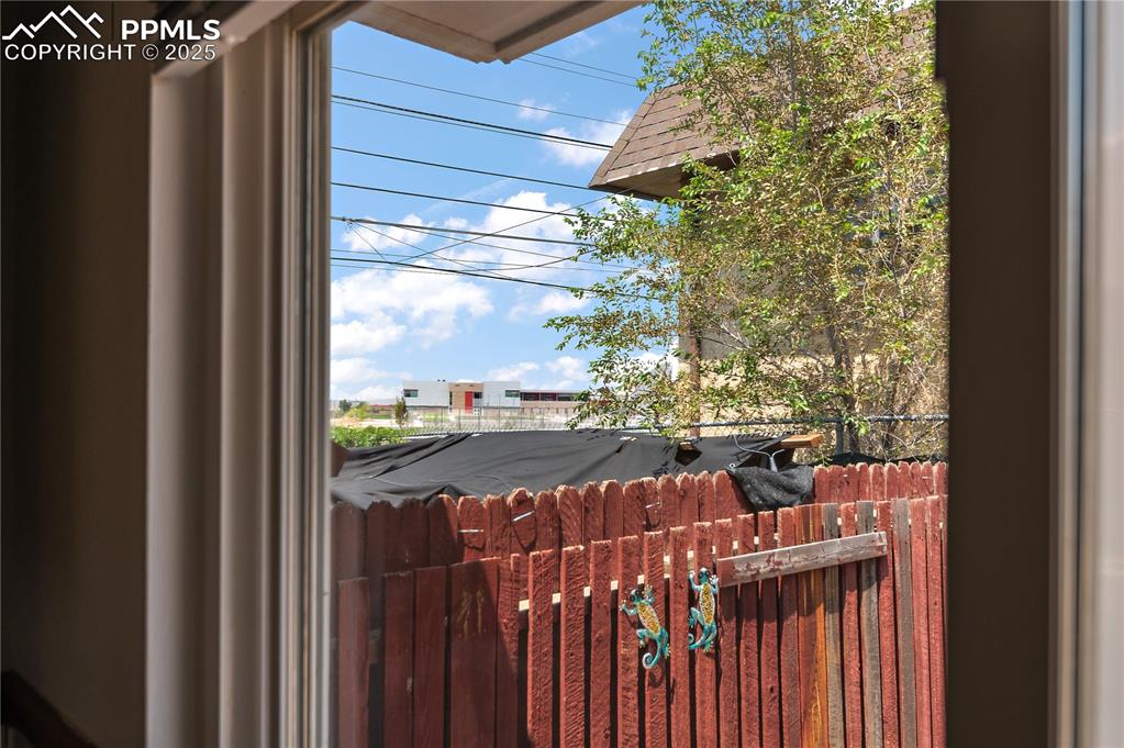 Image 21 of 25: Rear Patio is Fully Fenced and Looks Out to the New Centennial High School
