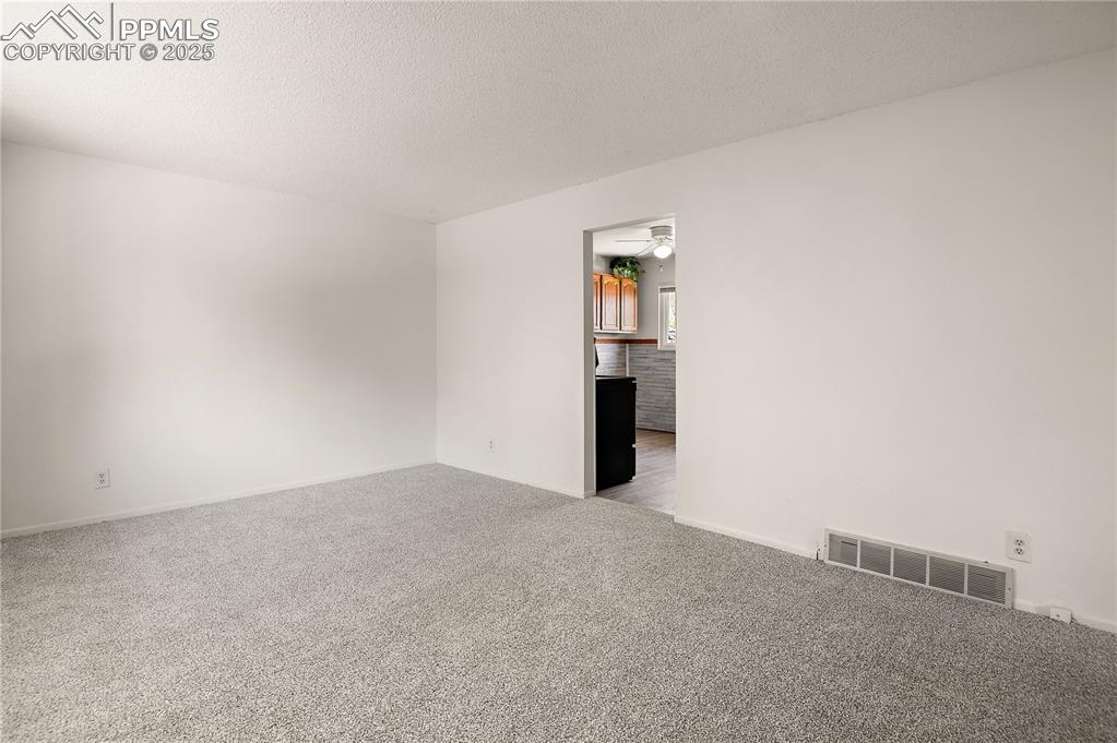 Image 5 of 25: Living Area Looking into the Kitchen