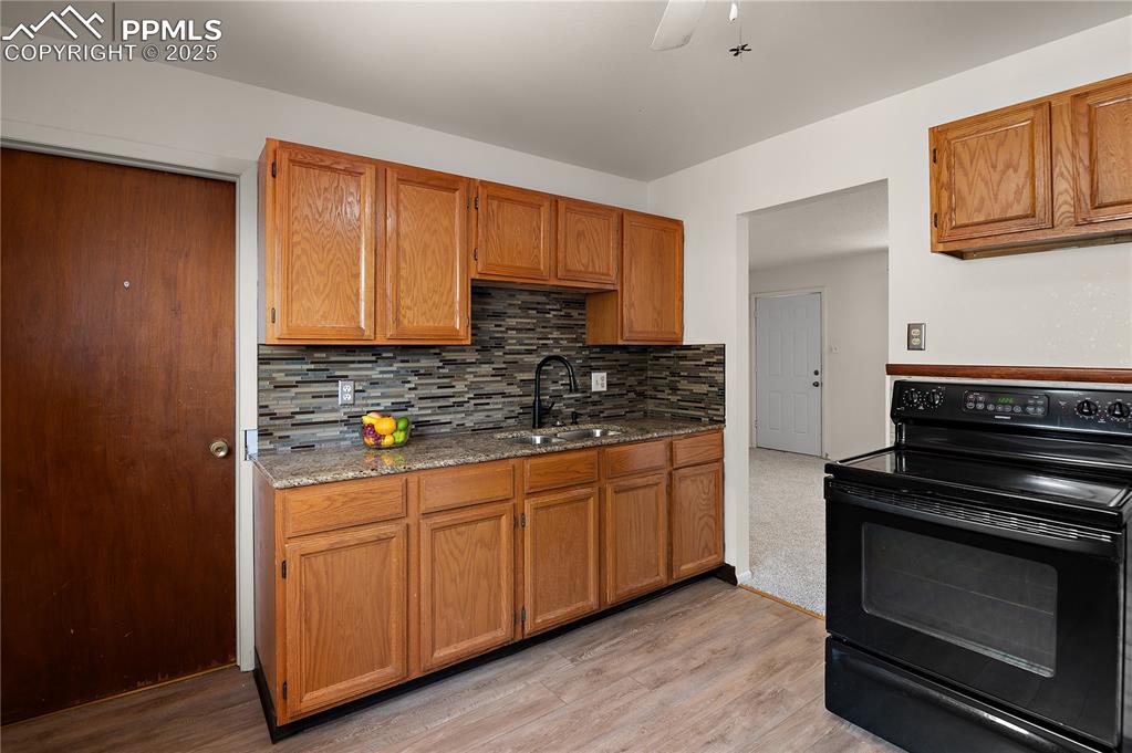 Image 9 of 25: The Ample Sized Kitchen Boasts Granite Counter Tops , Custom Tile Backsplas