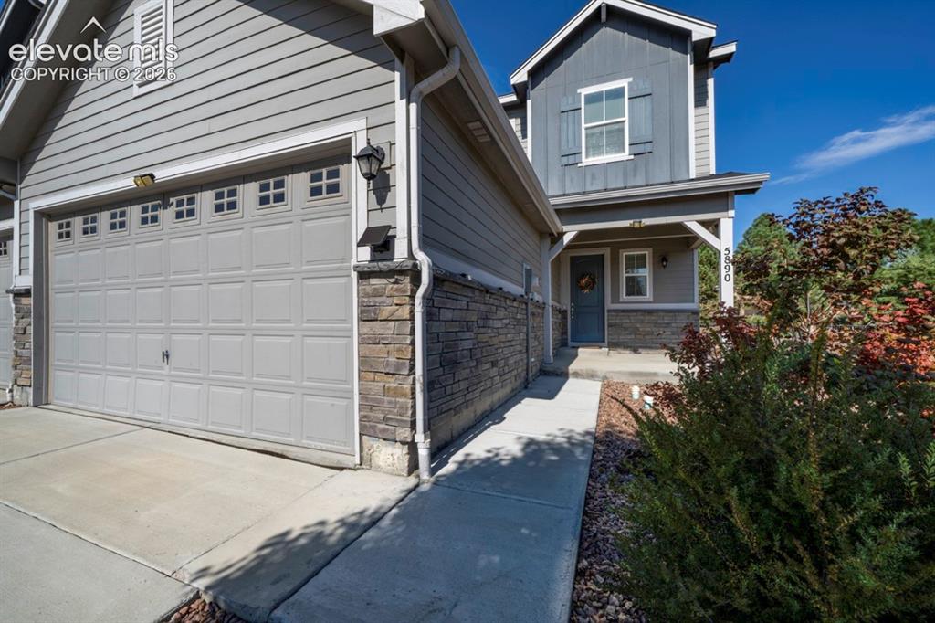 Caption: Two-story exterior with horizontal siding and stone accents
