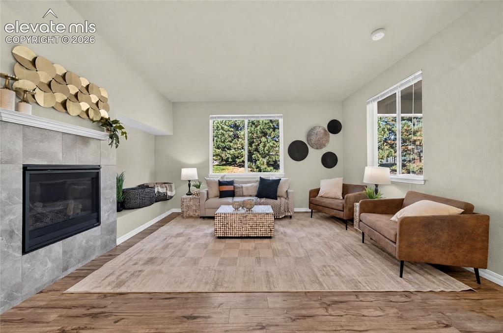 Image 13 of 41: Spacious room a tiled fireplace with a mantel