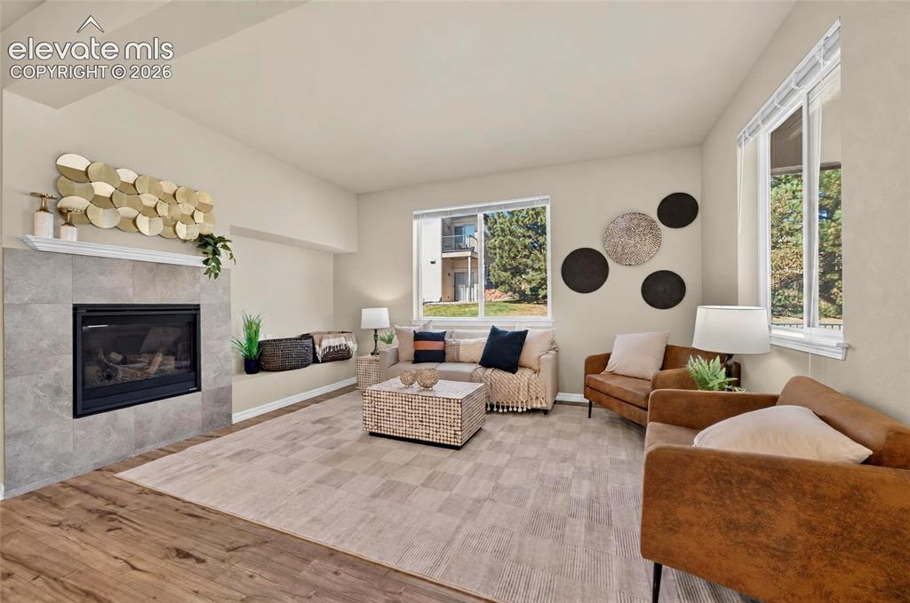 Image 14 of 41: Fireplace with tile surround and mantel
