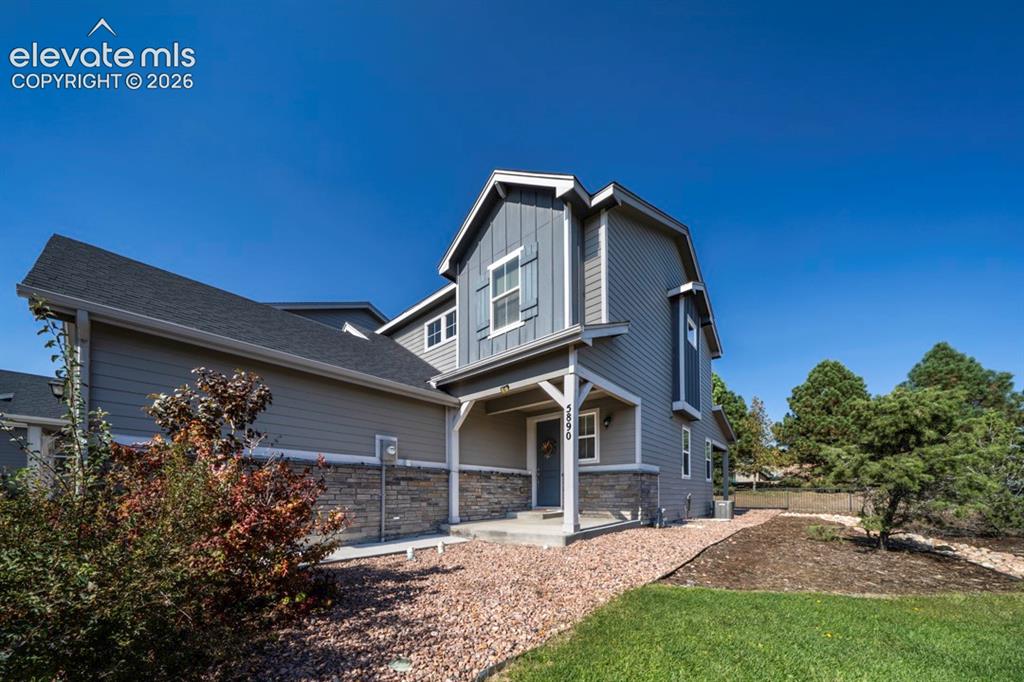 Image 2 of 41: Multi-level exterior with siding and stone accents, covered entry, and gabl