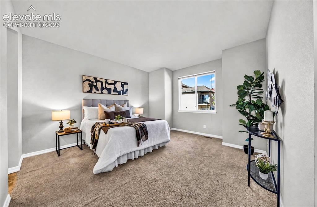Image 20 of 41: Spacious room featuring neutral wall tones, plush carpeting, a large window