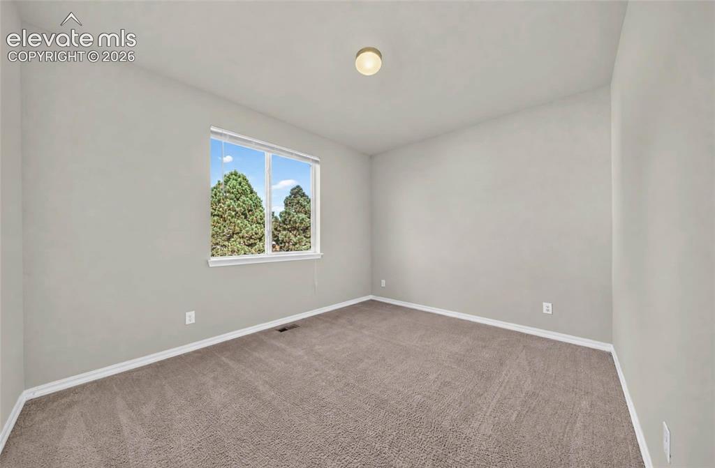 Image 27 of 41: Neutral-toned walls with carpet flooring