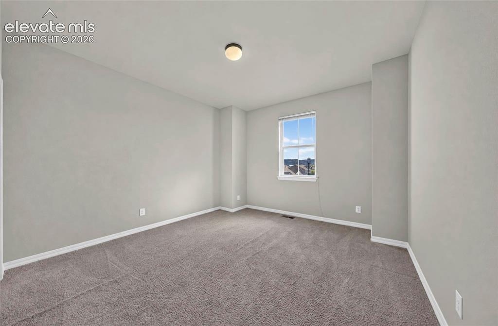 Image 29 of 41: Neutral wall finishes, plush carpet flooring, recessed window, and overhead