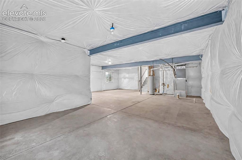 Image 31 of 41: Expansive unfinished space featuring concrete flooring, exposed structural