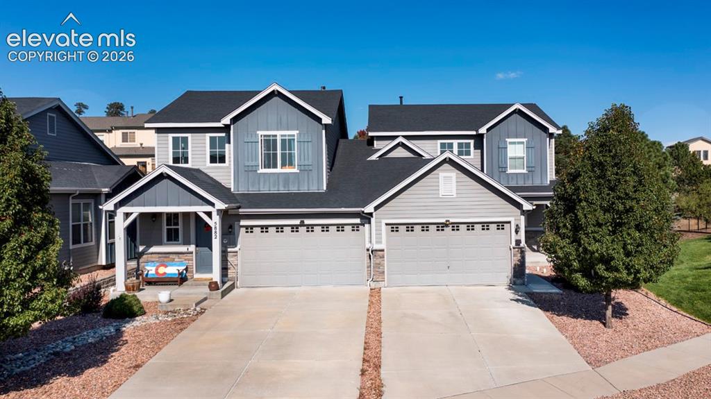 Image 36 of 41: Exterior showcasing a covered front porch, an attached two-car garage, and 