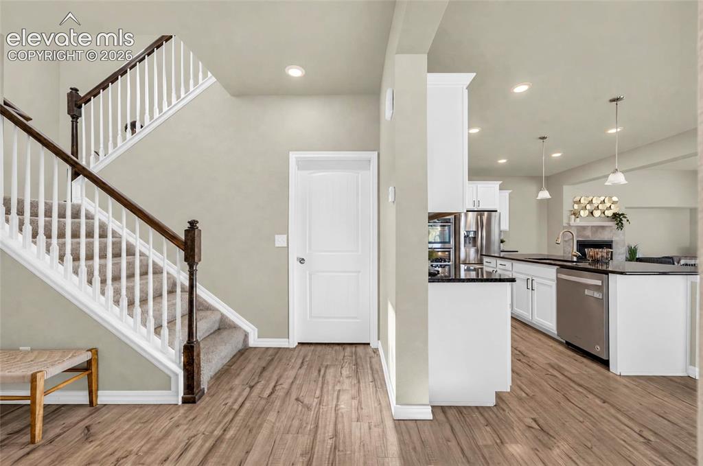 Image 5 of 41: Wood-laminate finish flooring throughout, white paneled interior doors, rec