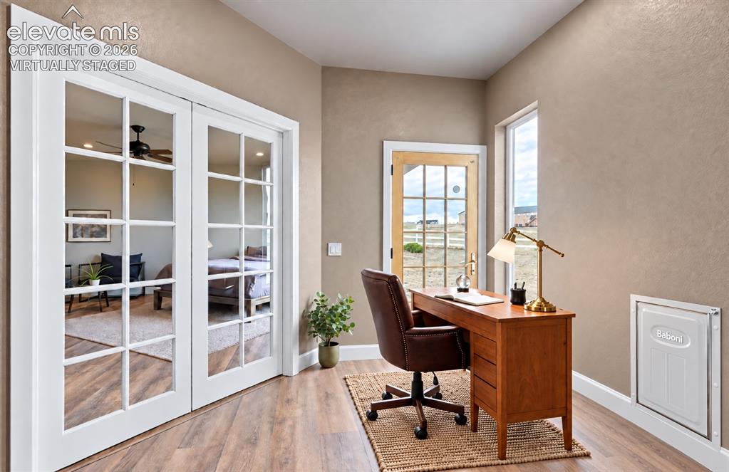 Image 28 of 48: Virtually Staged Wood-finish flooring with a textured area rug