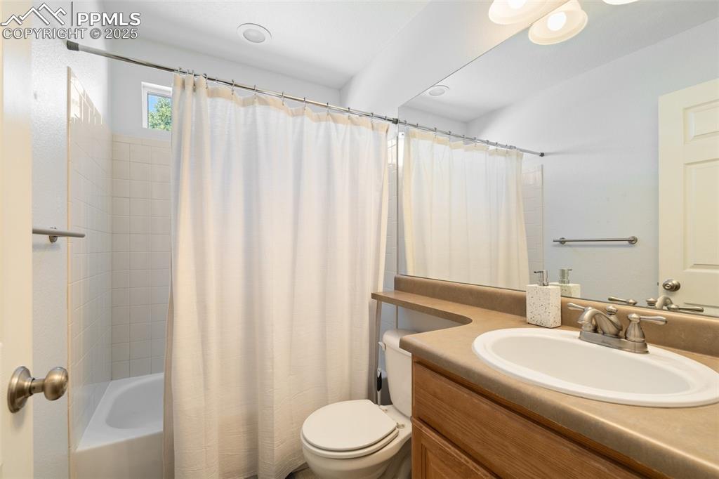 Image 14 of 38: Main level full bathroom with a shower / tub combo