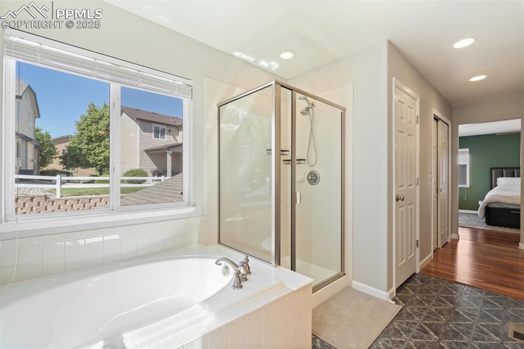 Image 24 of 38: Large soaking tub and free standing shower