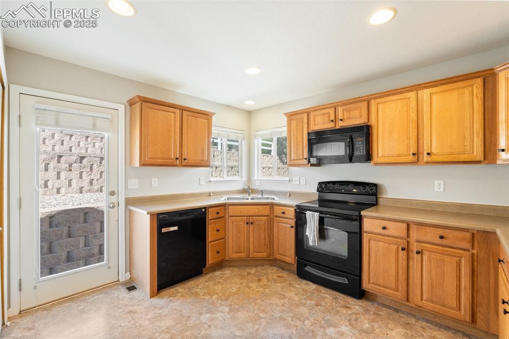 Image 8 of 38: Walkout access from the kitchen along with wrap-around cabinets