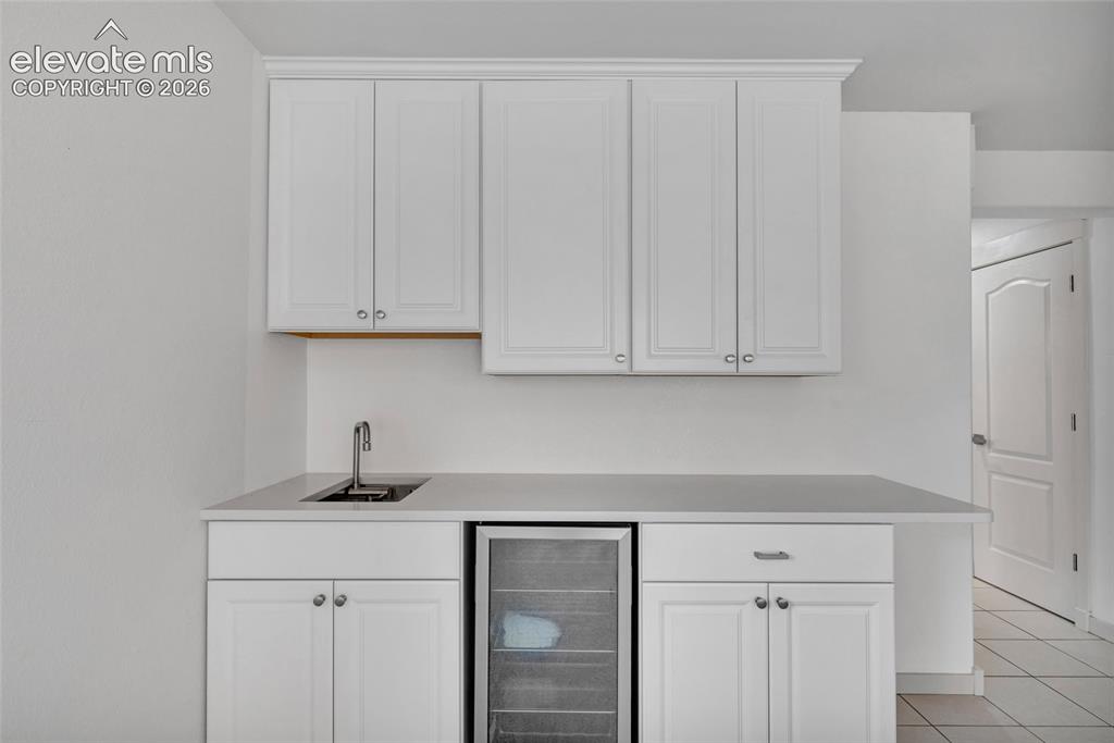 Image 36 of 50: Wet bar w/collapsible faucet in basement rec room