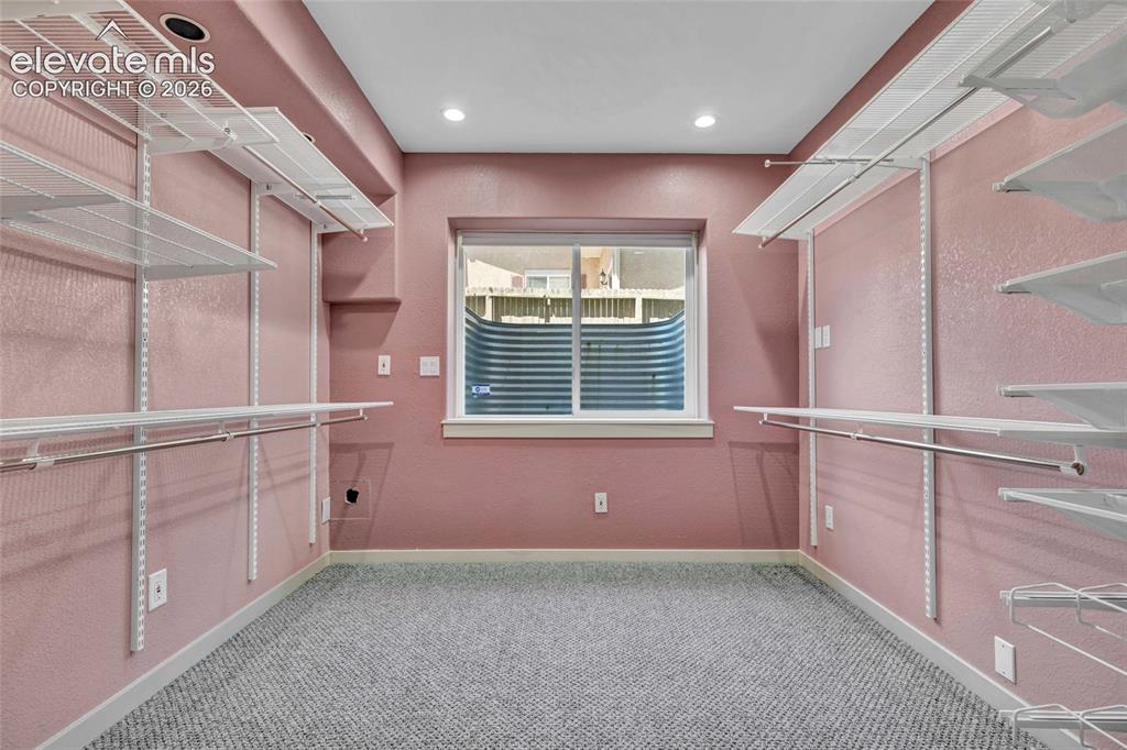 Image 46 of 50: Finished basement room for storage or an office