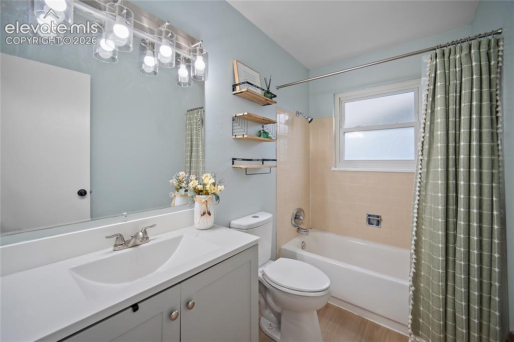 Image 10 of 18: Vanity with an integrated sink, brushed nickel faucet, large wall mirror, a