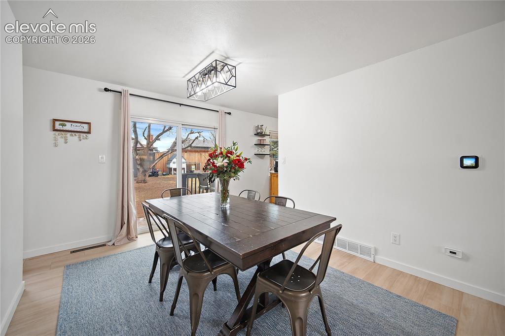 Image 4 of 18: Recessed ceiling lighting, wood-finish flooring, and a modern geometric lig
