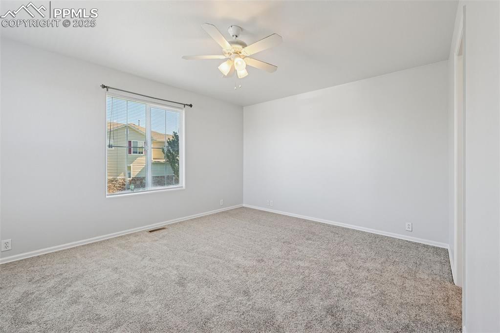 Image 17 of 31: Spare room with carpet and a ceiling fan