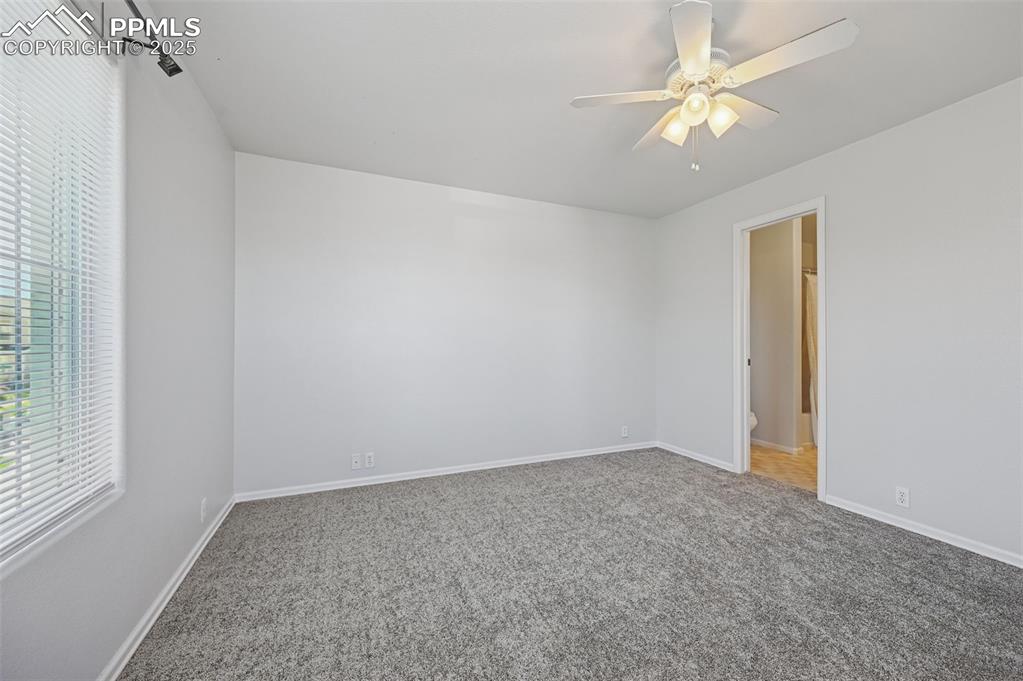 Image 19 of 31: Unfurnished bedroom with carpet and ceiling fan