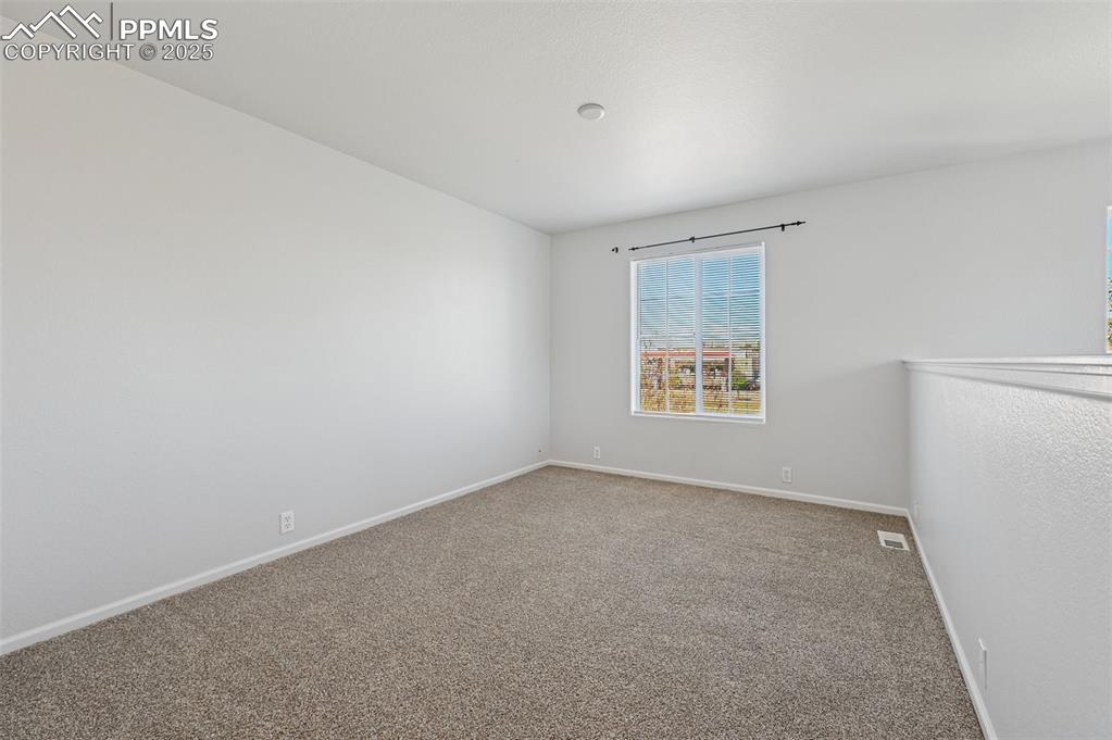 Image 21 of 31: Empty room with carpet flooring and baseboards