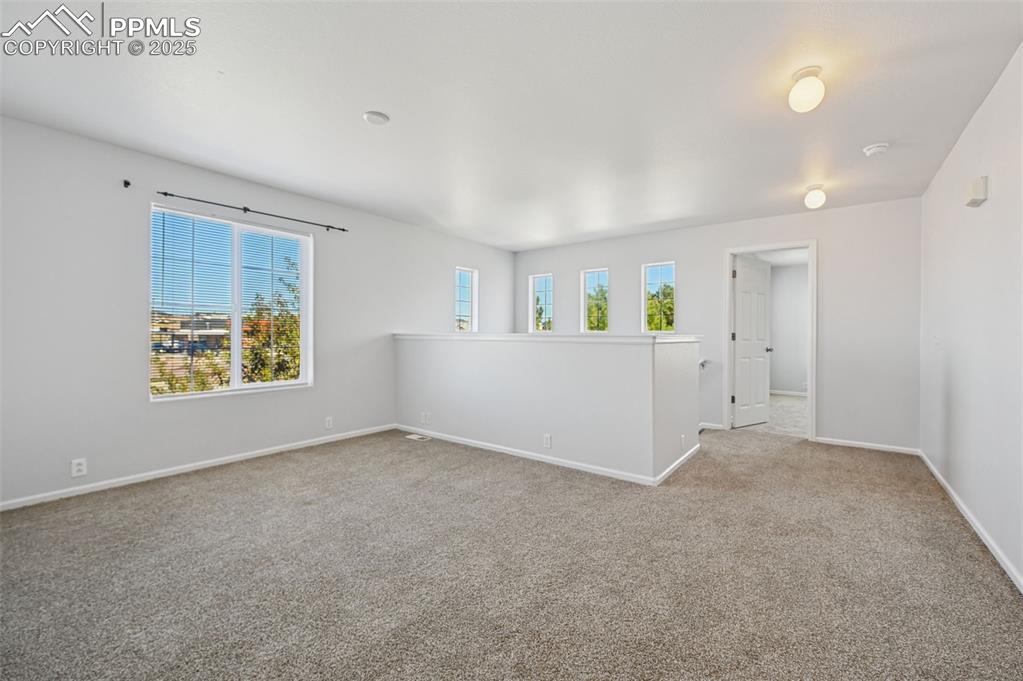 Image 22 of 31: Empty room featuring carpet and baseboards