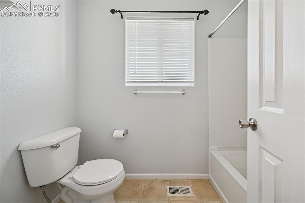 Image 29 of 31: Bathroom with bathtub / shower combination and tile patterned floors