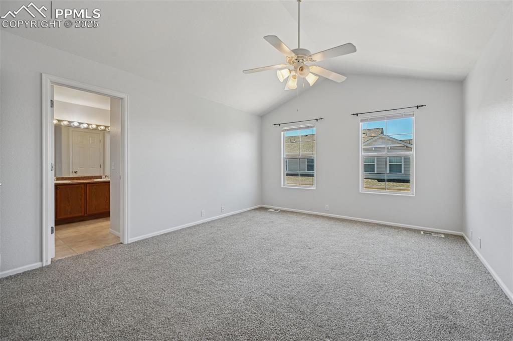 Image 30 of 31: Unfurnished bedroom featuring lofted ceiling, light carpet, ceiling fan, an
