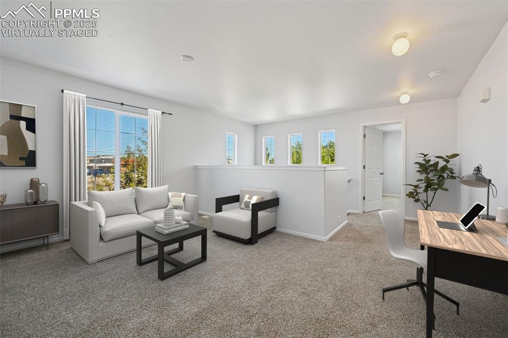 Image 4 of 31: Carpeted living room with baseboards. virtually staged