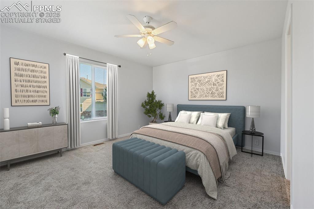Image 6 of 31: Carpeted bedroom featuring a ceiling fan and baseboards. virtually staged