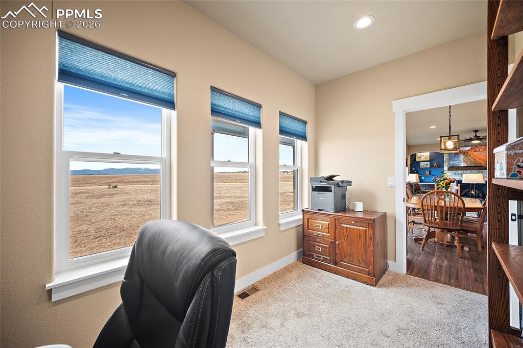 Image 10 of 49: Main level office with mountain views.