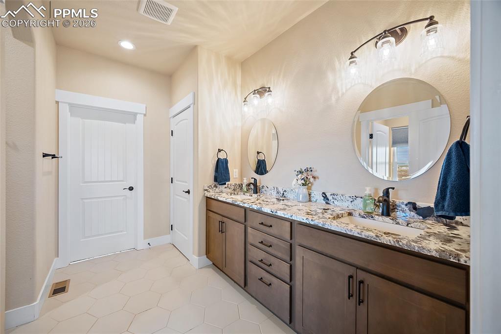 Image 16 of 49: Quartz countertops and dual vanities.