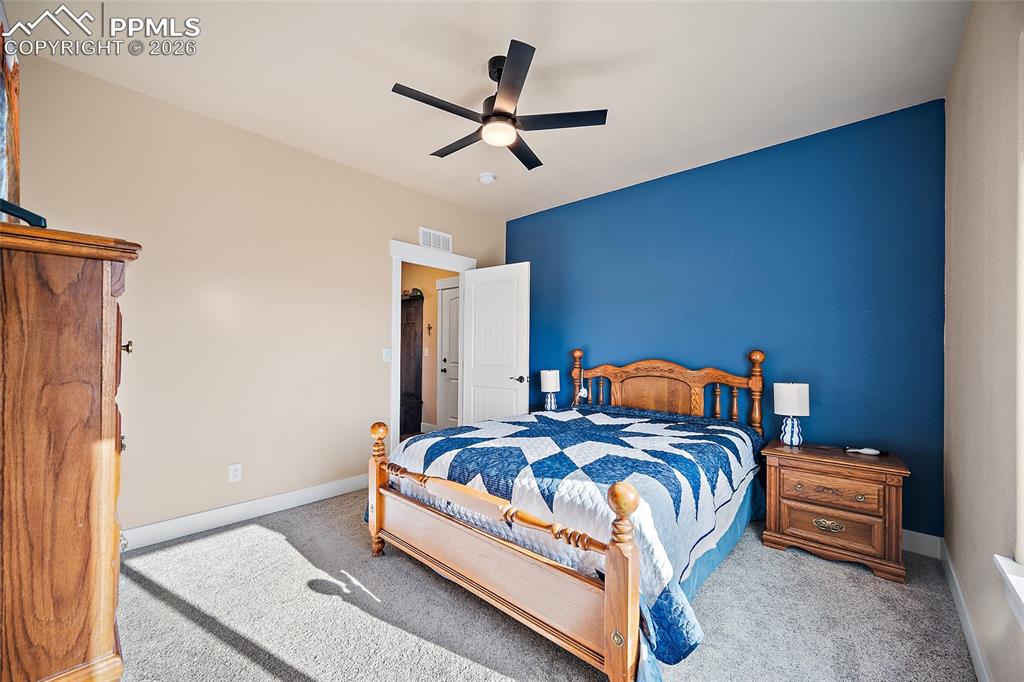 Image 20 of 49: Main level bedroom with walk in closet and private bathroom.