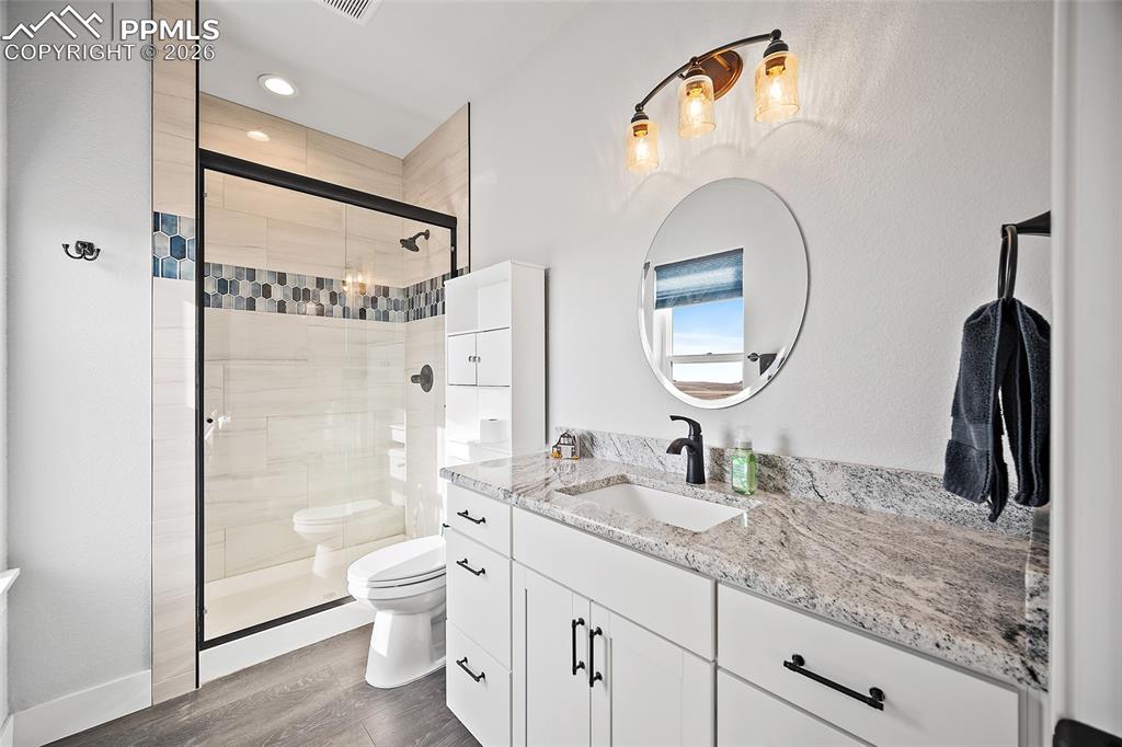 Image 22 of 49: Private bathroom in main level bedroom.