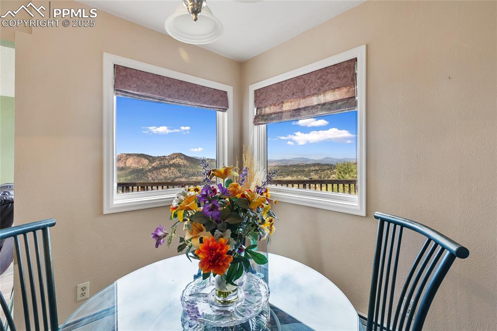 Image 15 of 48: Dining room with a mountain view and a textured wall