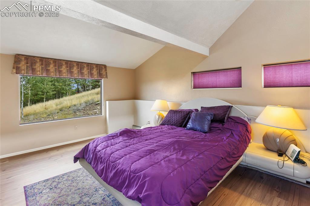 Image 24 of 48: Bedroom featuring wood finished floors and baseboards