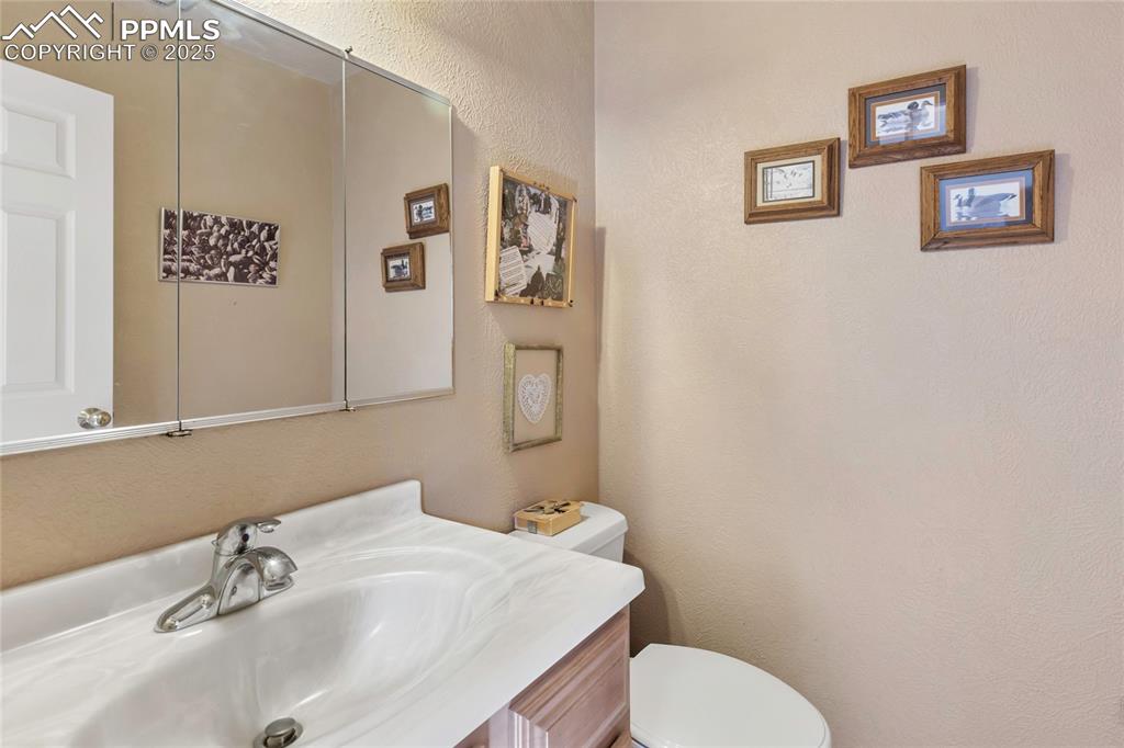 Image 32 of 48: Bathroom featuring a textured wall and vanity