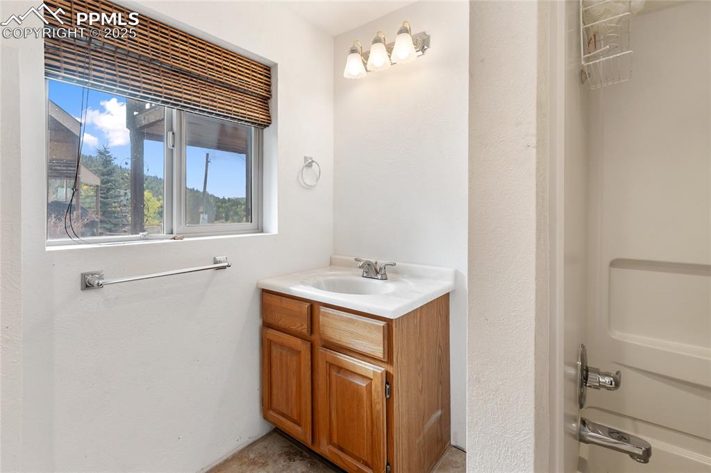 Image 37 of 48: Full bath featuring vanity and  shower combination