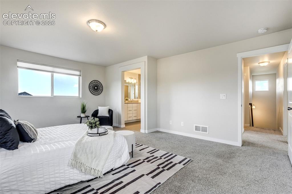 Image 23 of 44: The primary bedroom features an en suite bathroom.