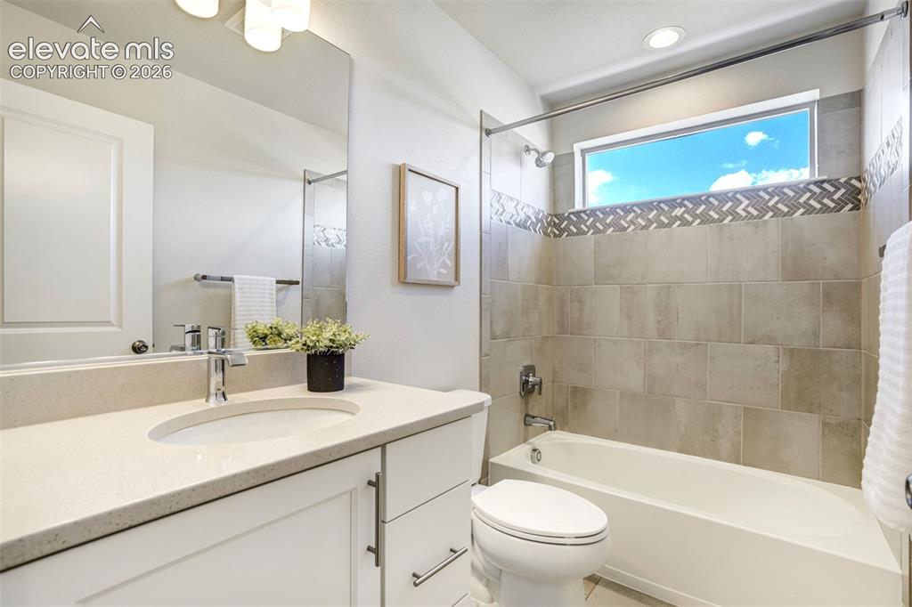 Image 33 of 44: Timeless design like Quartz counters & custom tile shower surround.