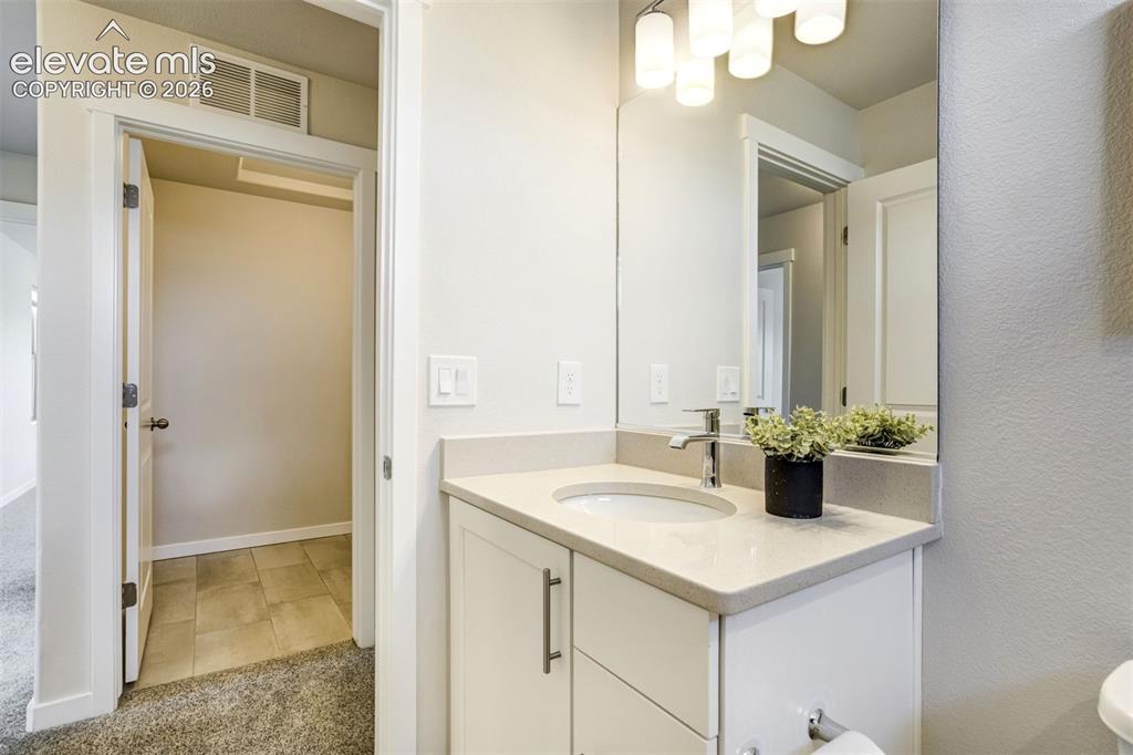 Image 34 of 44: Secondary bathroom upstairs with the laundry room across the hall.