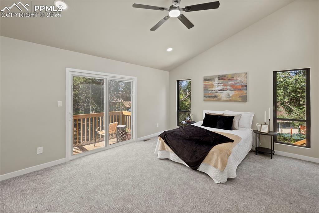 Image 19 of 50: Bedroom with carpet floors, multiple windows, access to outside, recessed l