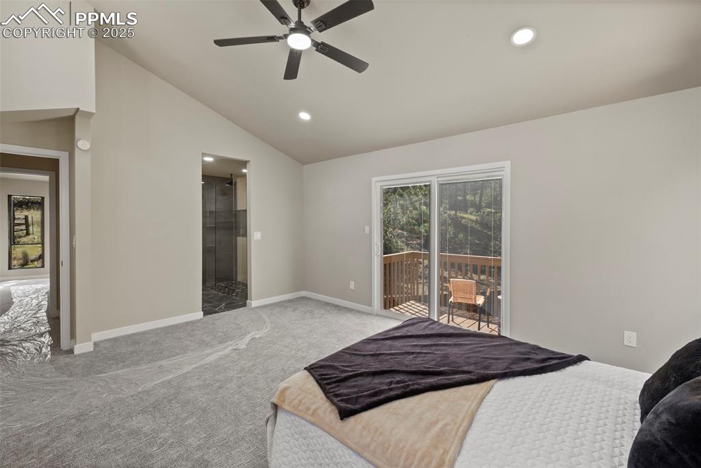 Image 20 of 50: Bedroom featuring vaulted ceiling, access to exterior, recessed lighting, c