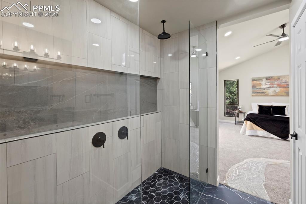 Image 24 of 50: Full bath featuring walk in shower, lofted ceiling, recessed lighting, a ce