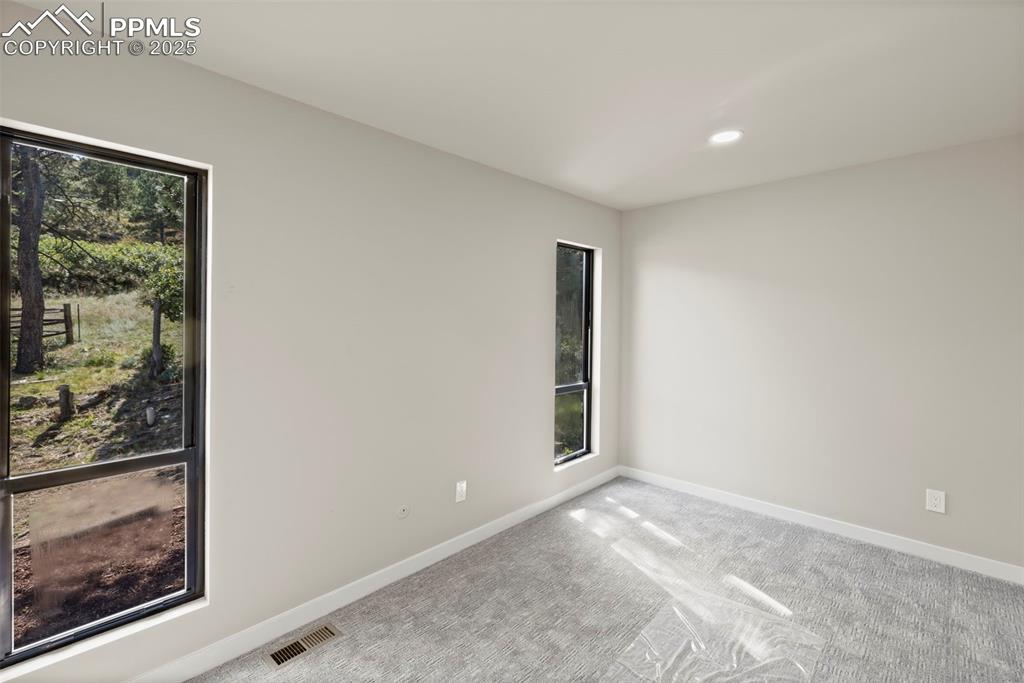 Image 27 of 50: Carpeted spare room featuring baseboards and recessed lighting