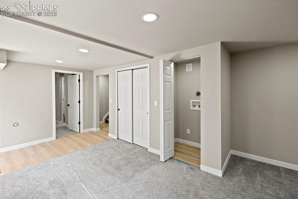 Image 33 of 50: Basement featuring recessed lighting, carpet flooring, and wood finished fl