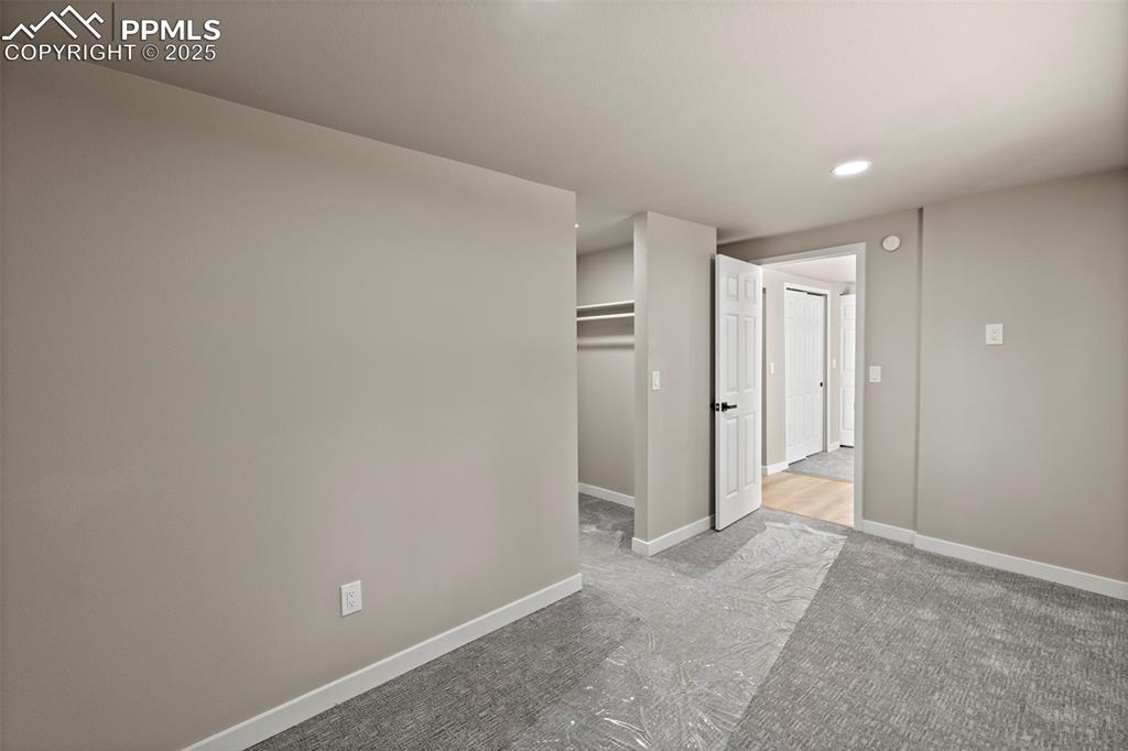 Image 36 of 50: Unfurnished bedroom featuring a closet, carpet flooring, and recessed light