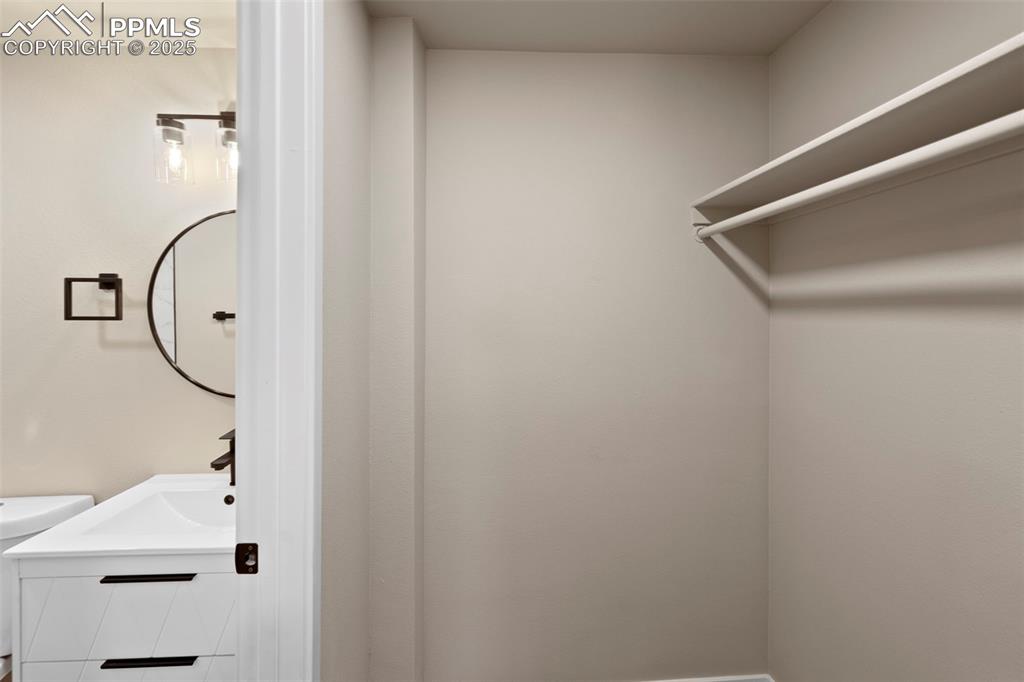 Image 37 of 50: Spacious closet featuring a sink