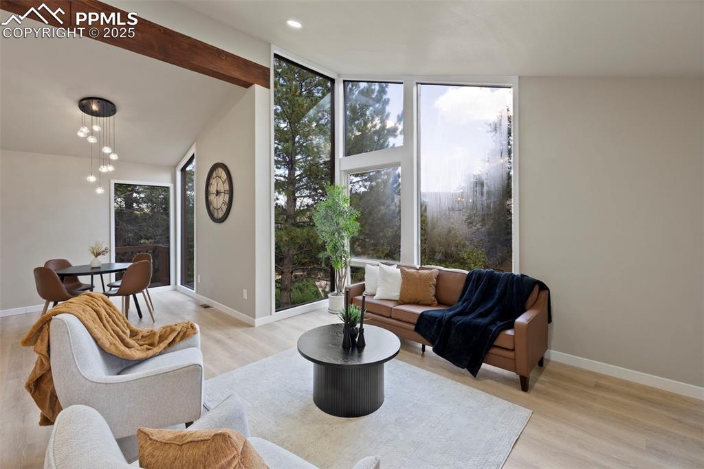 Image 4 of 50: Living room with plenty of natural light and light wood-style floors
